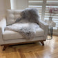 grey sheepskin rug on chair