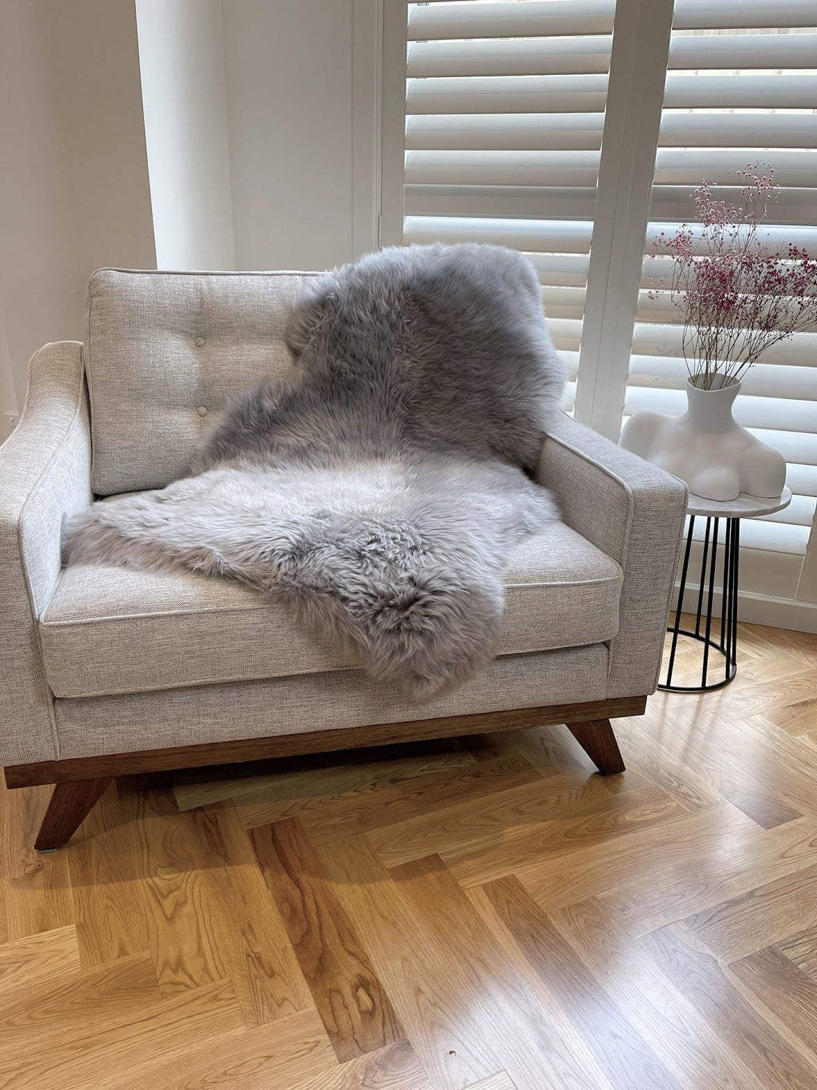 grey sheepskin rug on chair