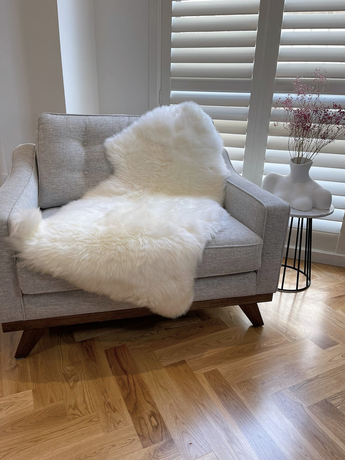 white sheepskin rug on lounge chair