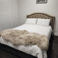 sheepskin rug on bed as throw blanket