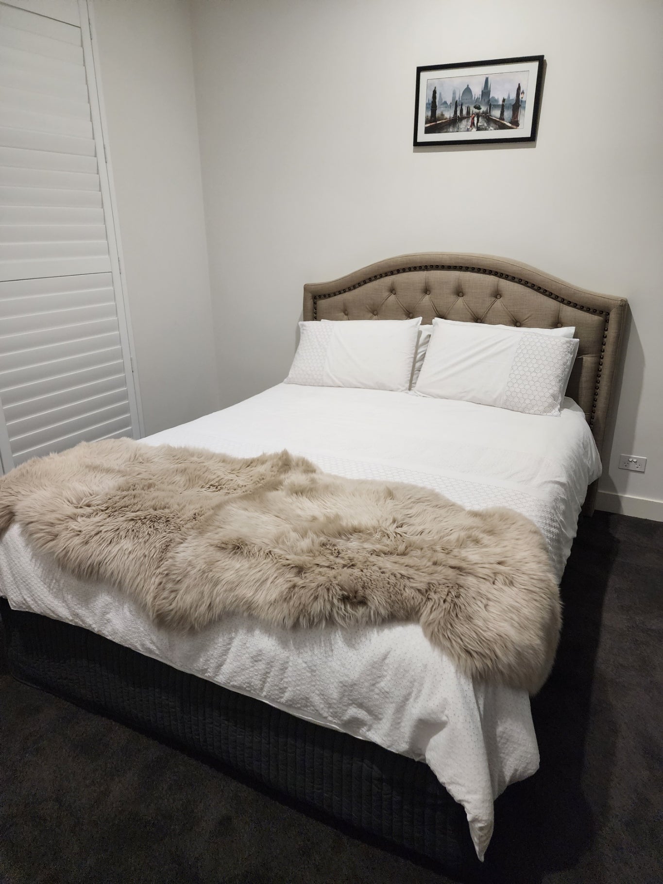 sheepskin rug on bed as throw blanket